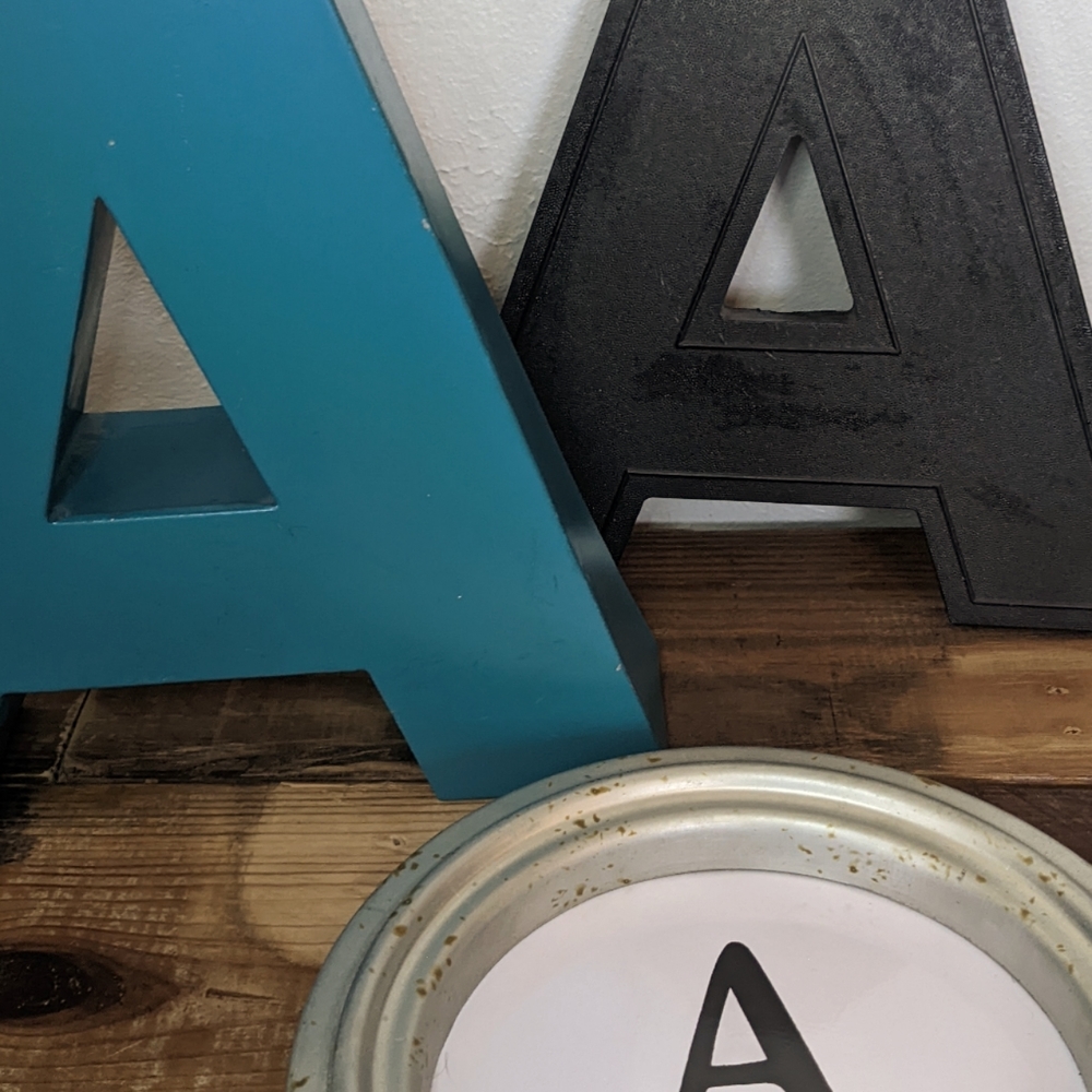 Grouping of the letter "A's" Black, Aqua and Old school typed A.